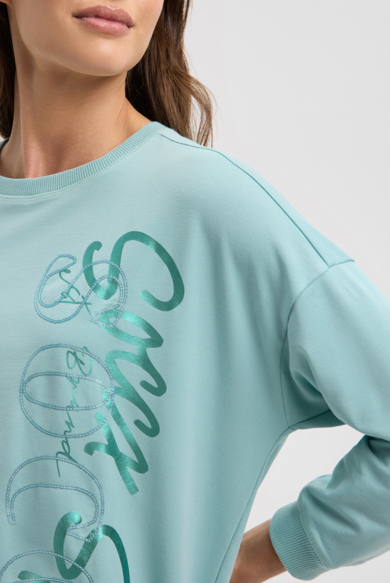 Mikina s elastickým lemem a flitrovým logem